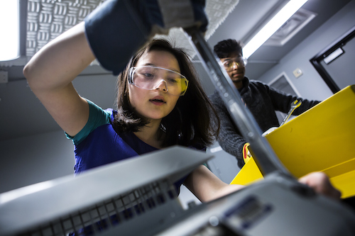 Female engineering student working in dyno lab.