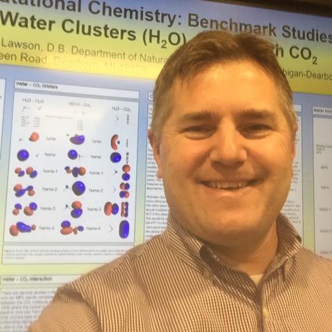 Daniel B. Lawson standing in front of a research poster