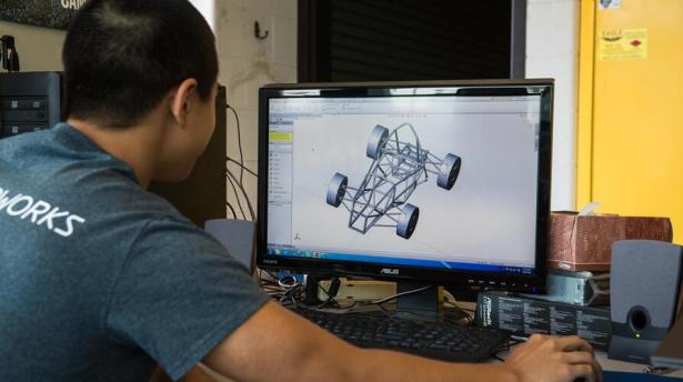 Student looking at a 3D CAD drawing on a computer