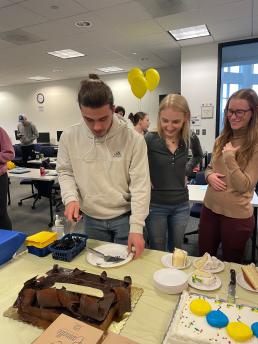 Celebration - students cutting and eating cake.
