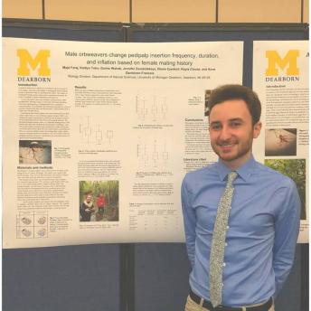 Majd Faraj standing in front of his research poster 