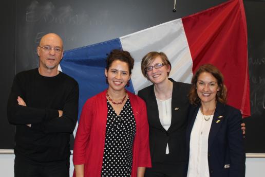 4 people standing in front of French flag