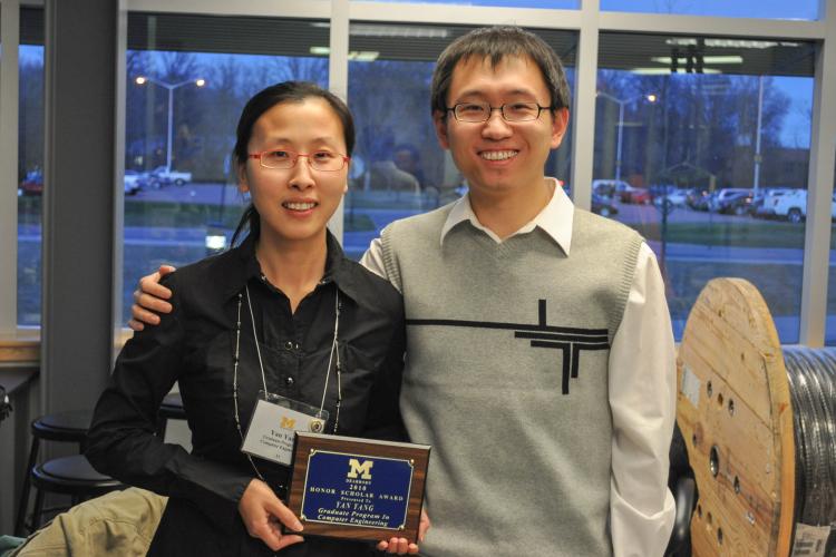 Xuan Zhou and his wife, Yan Yang, who holds a plaque after being awarded the Honors Scholar award in 2009.
