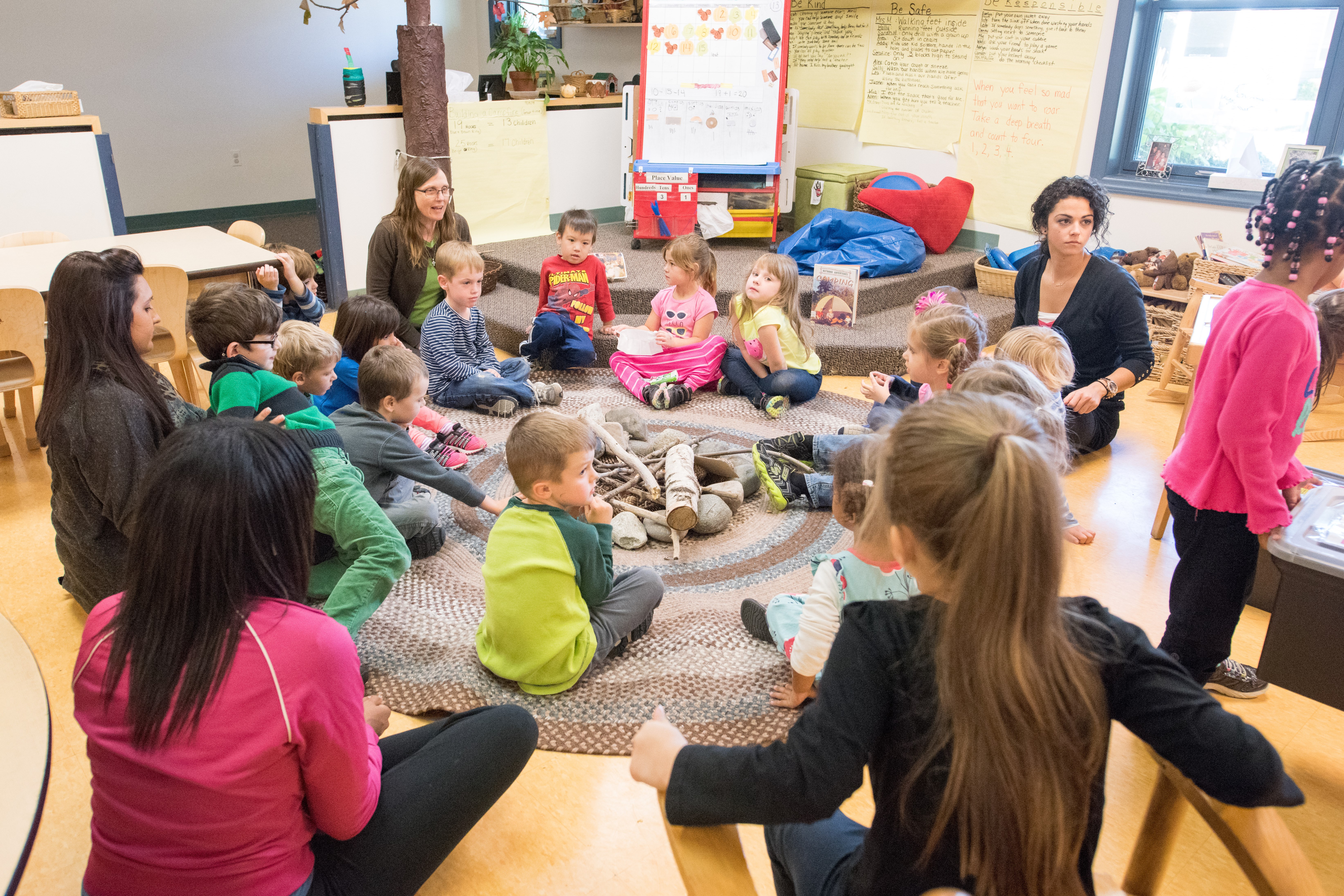 This is an image of young children having a discussion with their teachers.