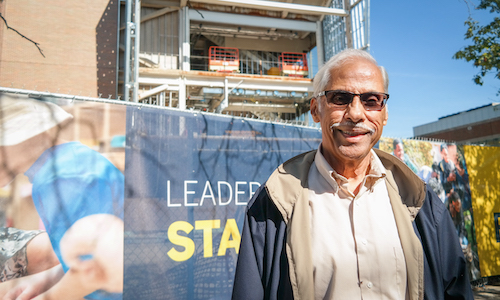 Professor Emeritus Malayappan Shridhar standing in front of the new Engineering Lab Building 