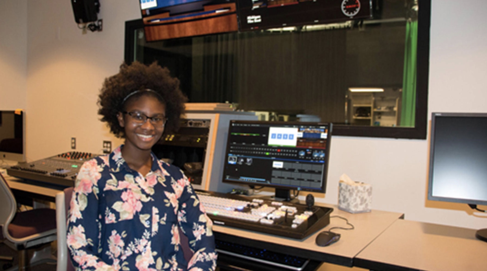  Tyesha Vinson, a senior journalism and screen studies student, sits behind the controls of the new JASS Studio 