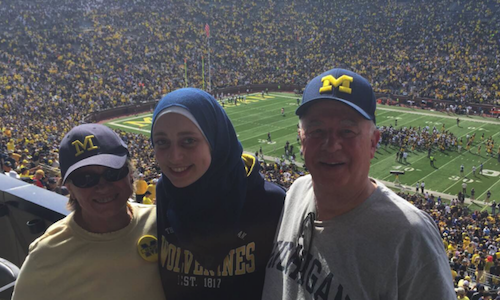  Biochemistry student Sarah Yahfoufi, center, enjoys a U-M football game with Dick and Linda Dyer. Yahfoufi, who graduates Sunday, is the first recipient of the four-year Dick and Linda Dyer Scholarship. 