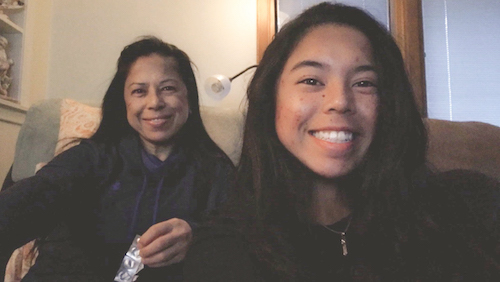 UM-Dearborn engineering student Maegan Cedro taking a selfie with her mom, a COVID unit nurse, at home.