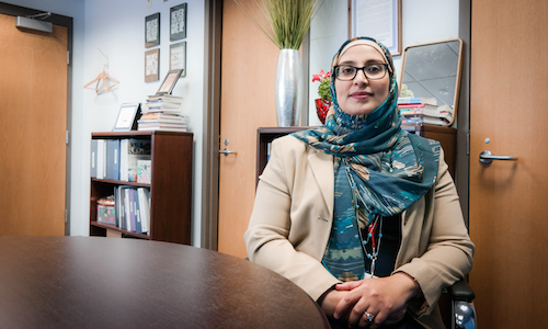  UM-Dearborn alumna and Hamtramck Public Schools superintendent Jaleelah Ahmed sitting in her office 