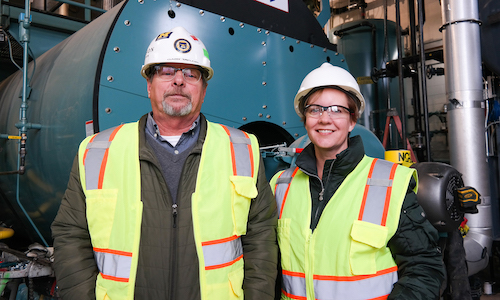 Gary Taylor and Emily Hamilton stand by UM-Dearborn steam boiler