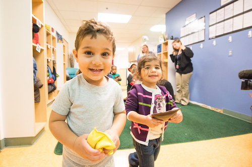  Smiling young children walk the halls of the Early Childhood Education Center 