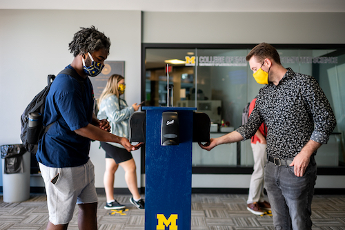  Students demo new hand sanitizer stations that have been installed across campus. 