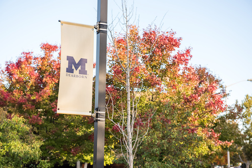 UM-Dearborn banner proudly displayed on an Autumn day.
