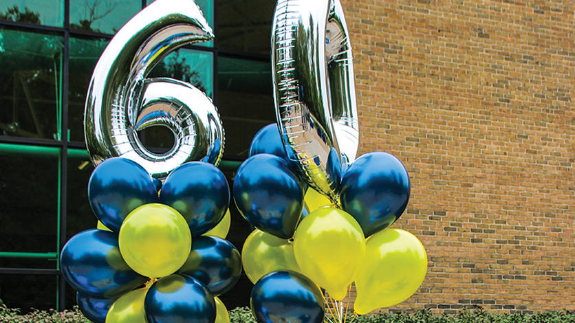 60 and maize and blue balloons