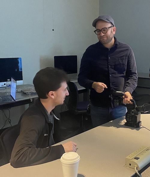 Assistant Professor Adam Sekuler, standing, discusses equipment with student Mike Hill. 