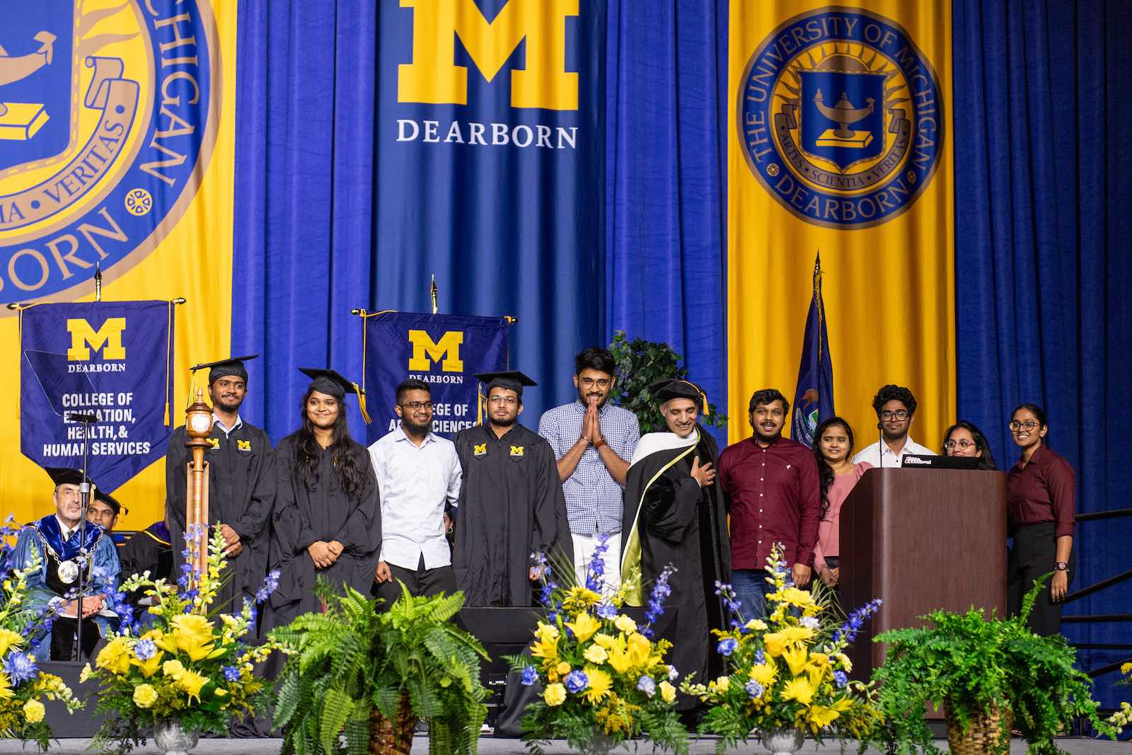 Photo of Professor Hafiz Malik and graduate students who created name announcing software for commencement