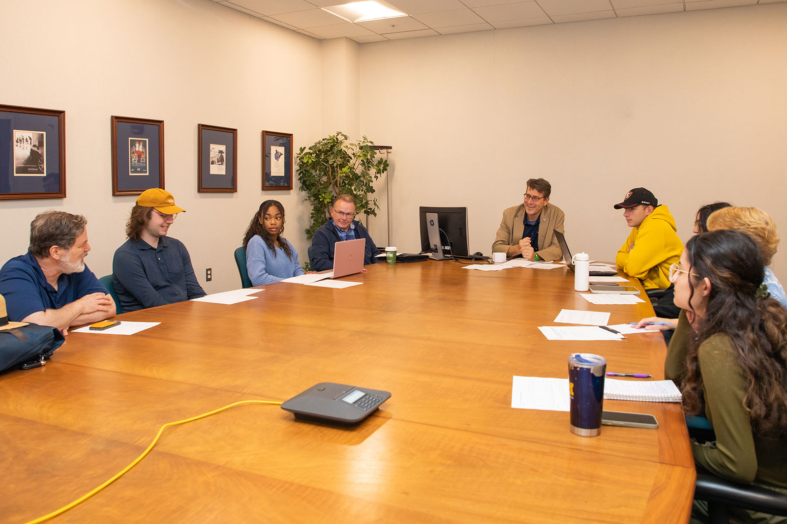 Group of students and professors talking in a conference room