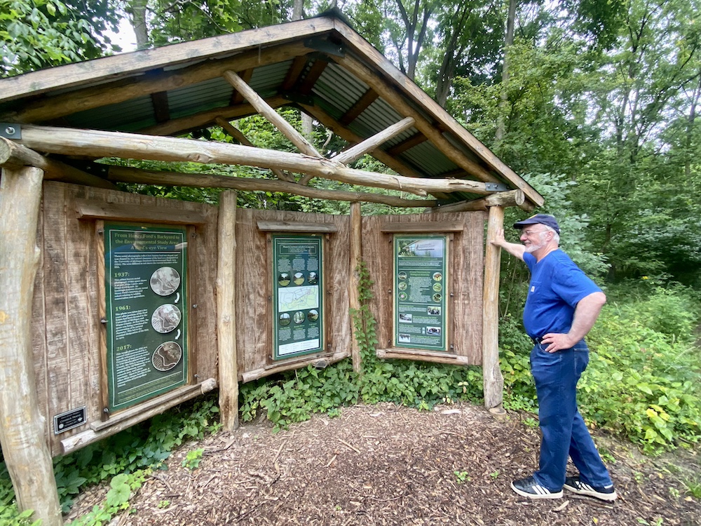 Rick Simek stands near the EiC trail head sign.