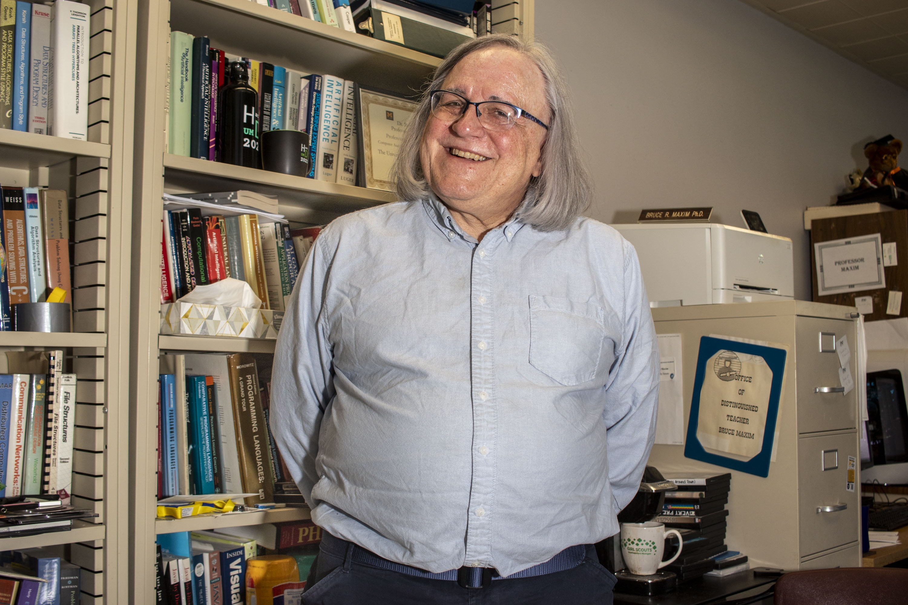 Professor Bruce Maxim stands in his office.