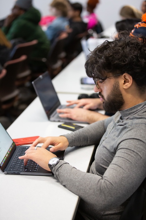 Student taking notes during lecture