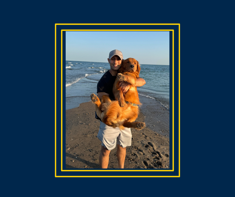 CASL staffer, Neal Patel holds his dog on a beach