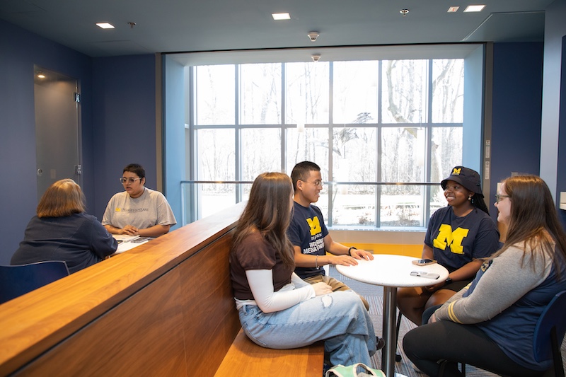 students gathered in a common area having a discussion