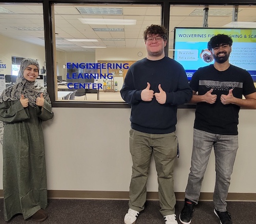Three students standing outside of the ELC. 