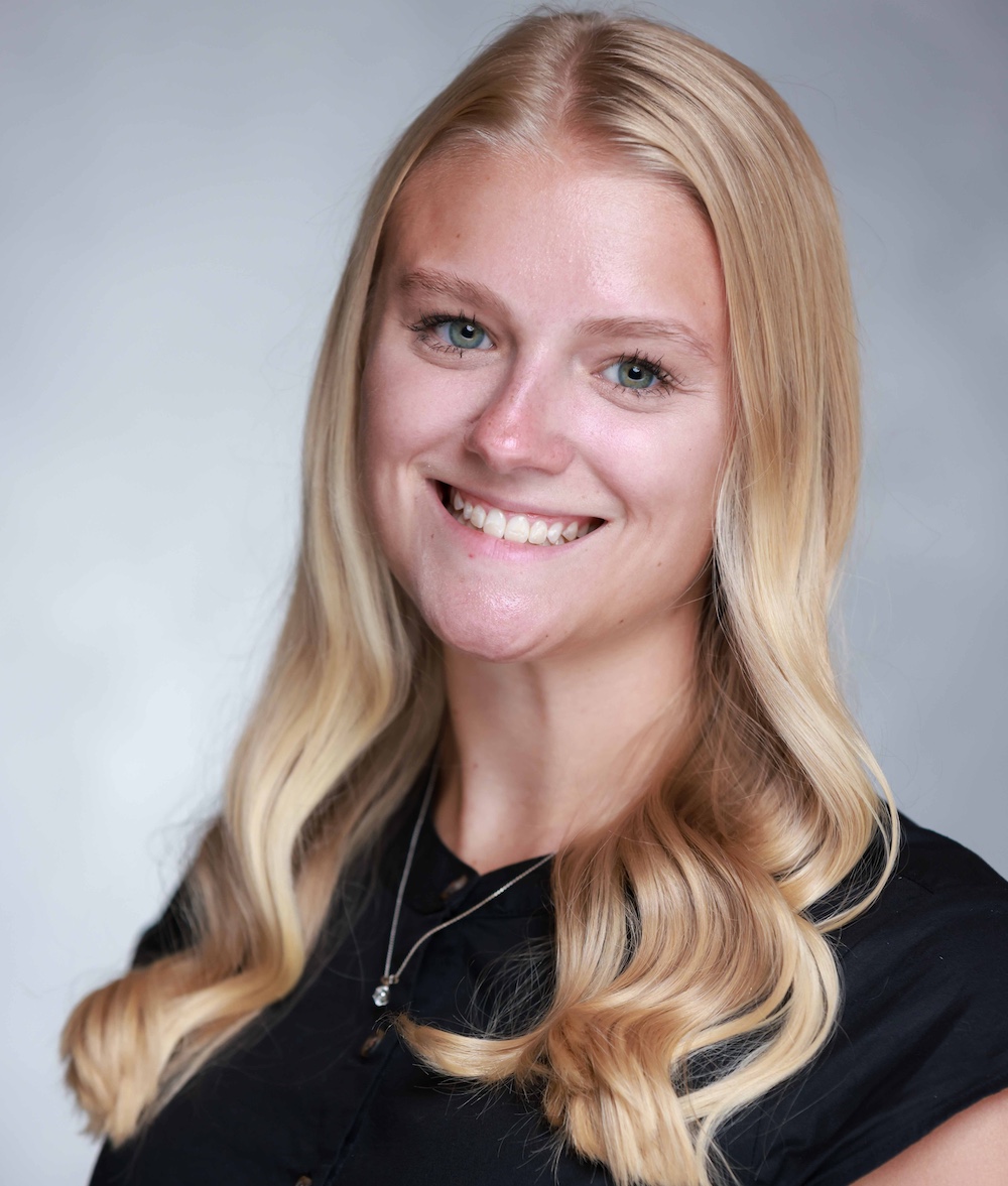 A photo of a blonde-haired woman with a black shirt