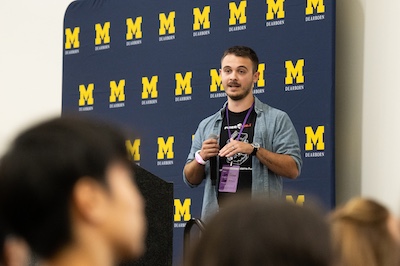 A man speaks at a podium to a group of college students