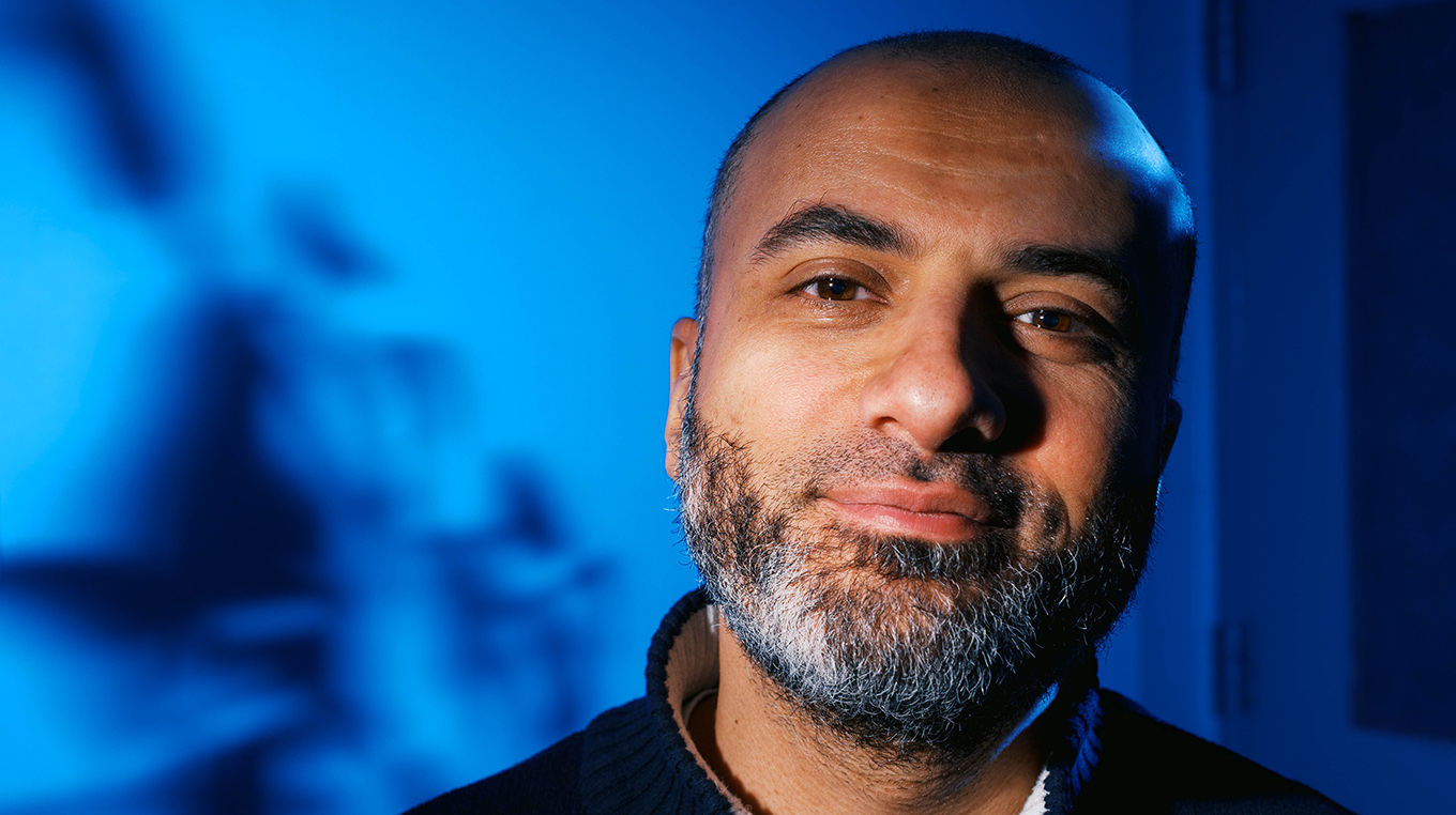 A closely cropped portrait of Associate Professor Mohamed Abouelenien set against a blue background