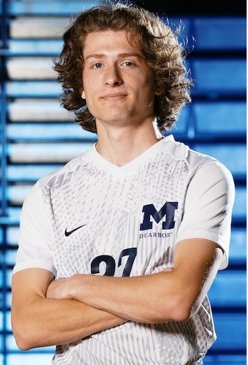 Noah Carmona, a man with his arms crossed