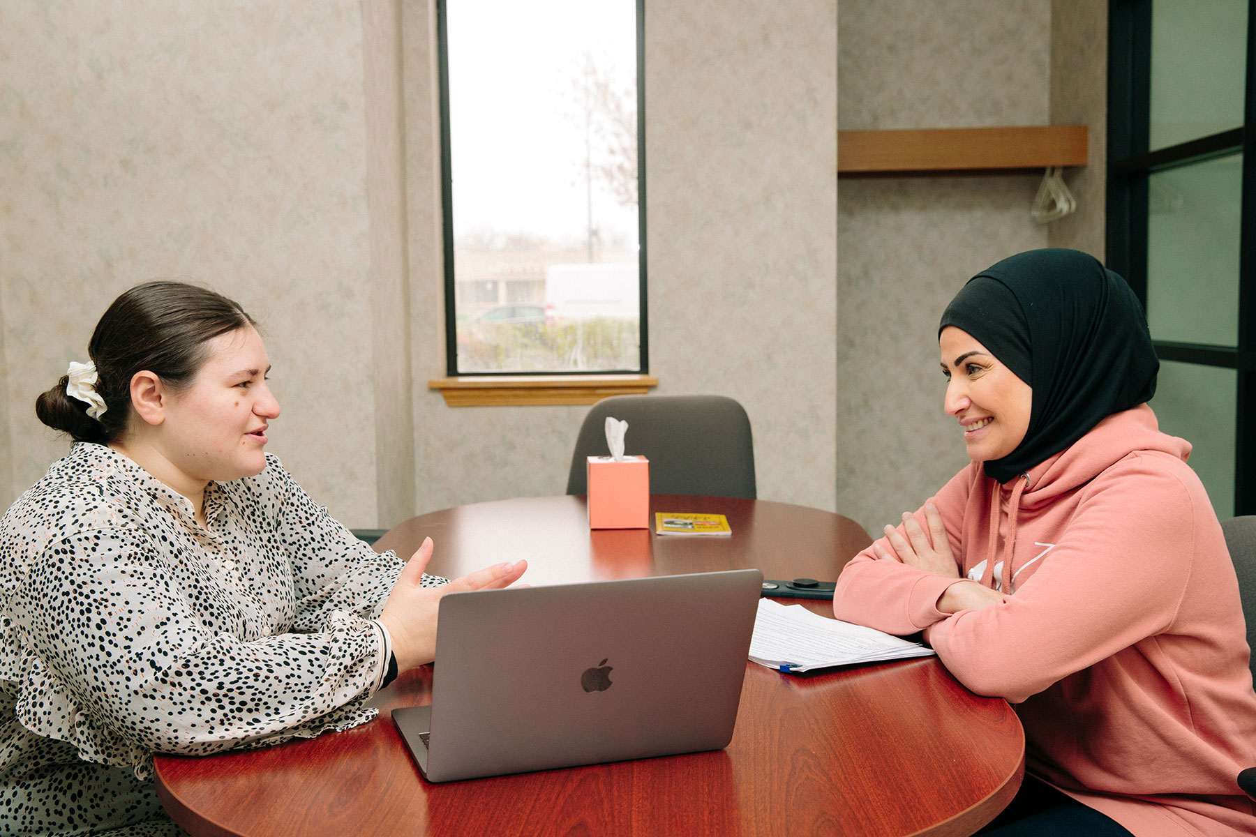 Two UM-Dearborn CEHHS students having a conversation at a round table