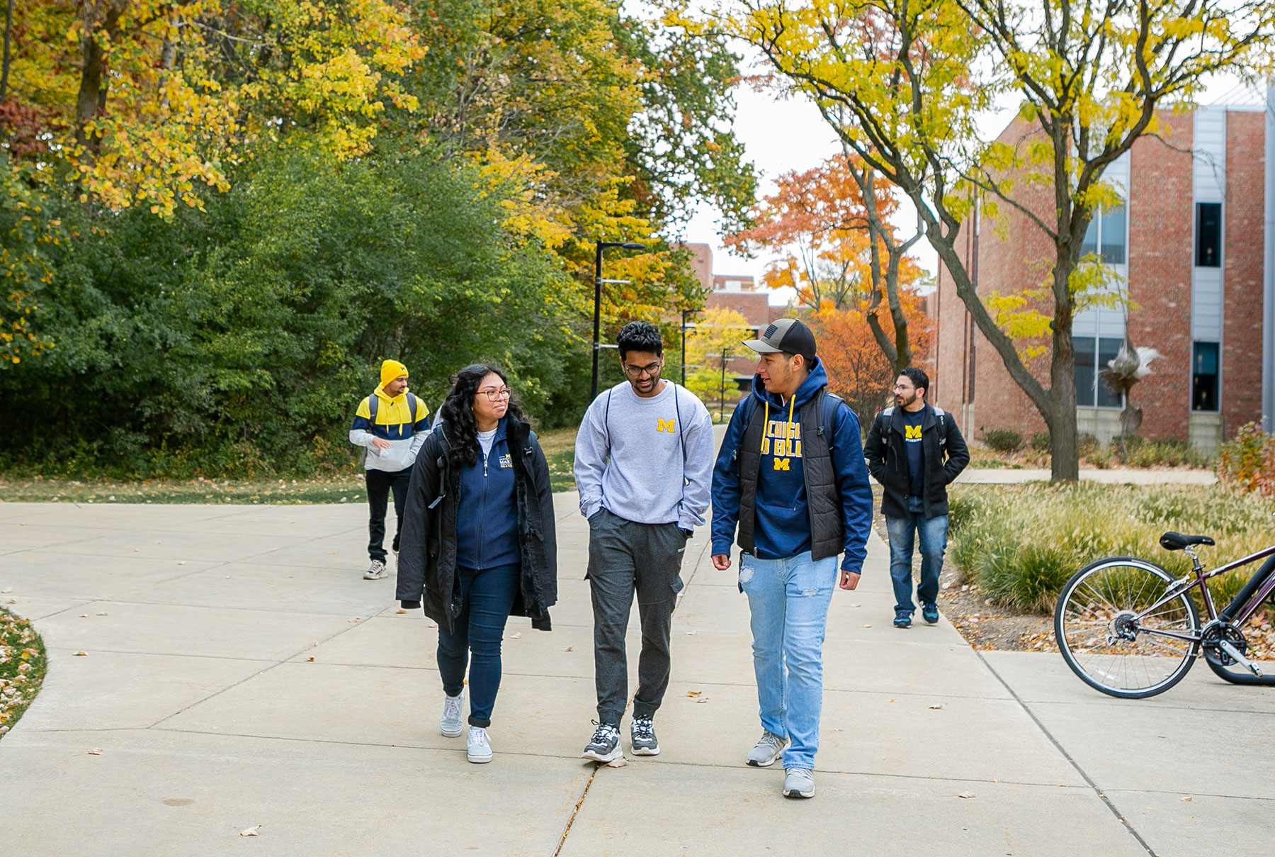 A group of UM-Dearborn students walking on campus in the fall.