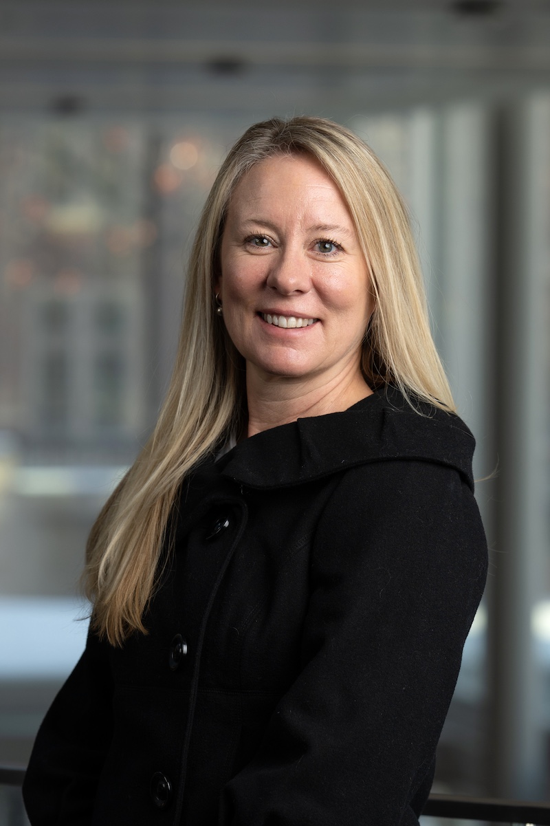 Photo of Rachel Roth Sawatzky Professional headshot photograph of a woman with long straight blond hair wearing a black suit jacket