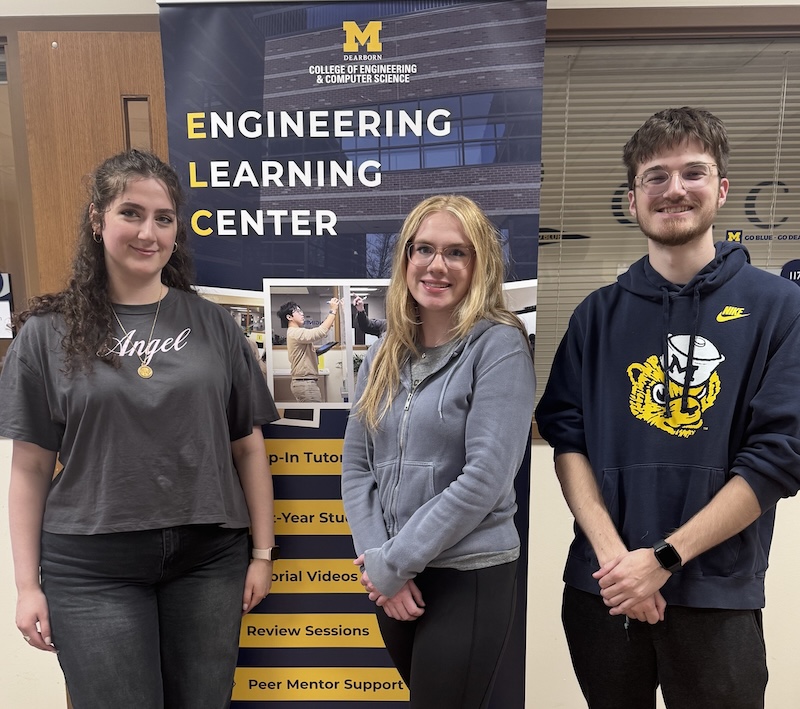 Three peer mentors standing in the ELC. 