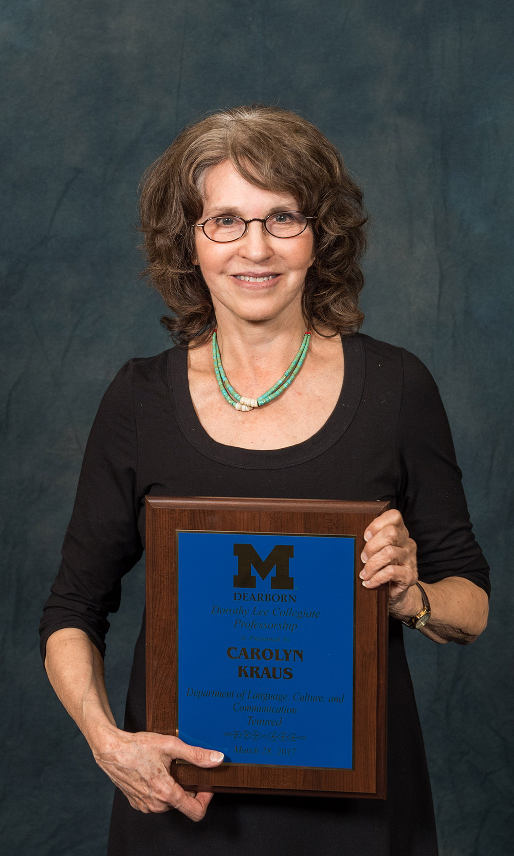 Carolyn Kraus holding an award
