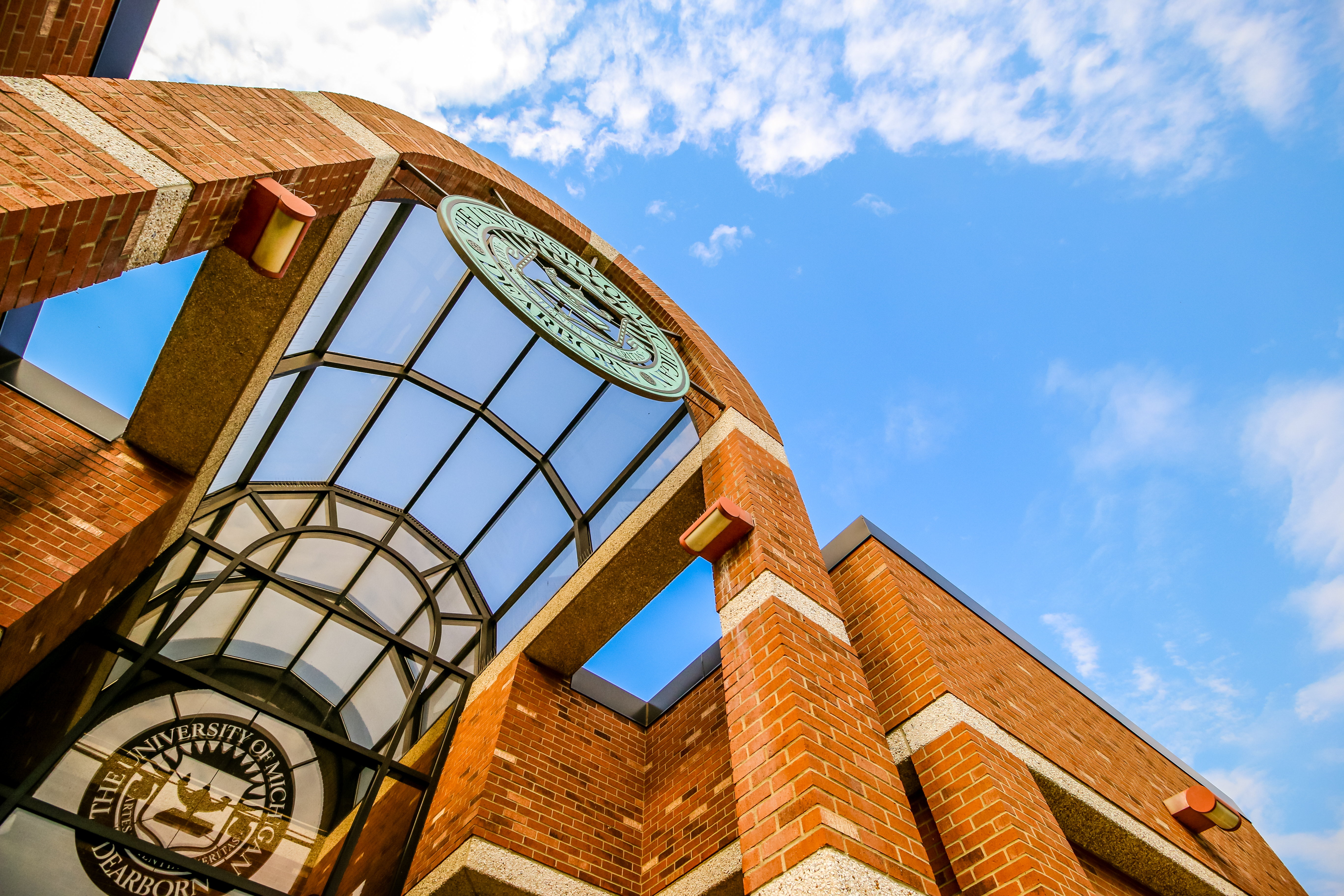 An artistic shot of the university seal on the Social Sciences Building set against a blue sky