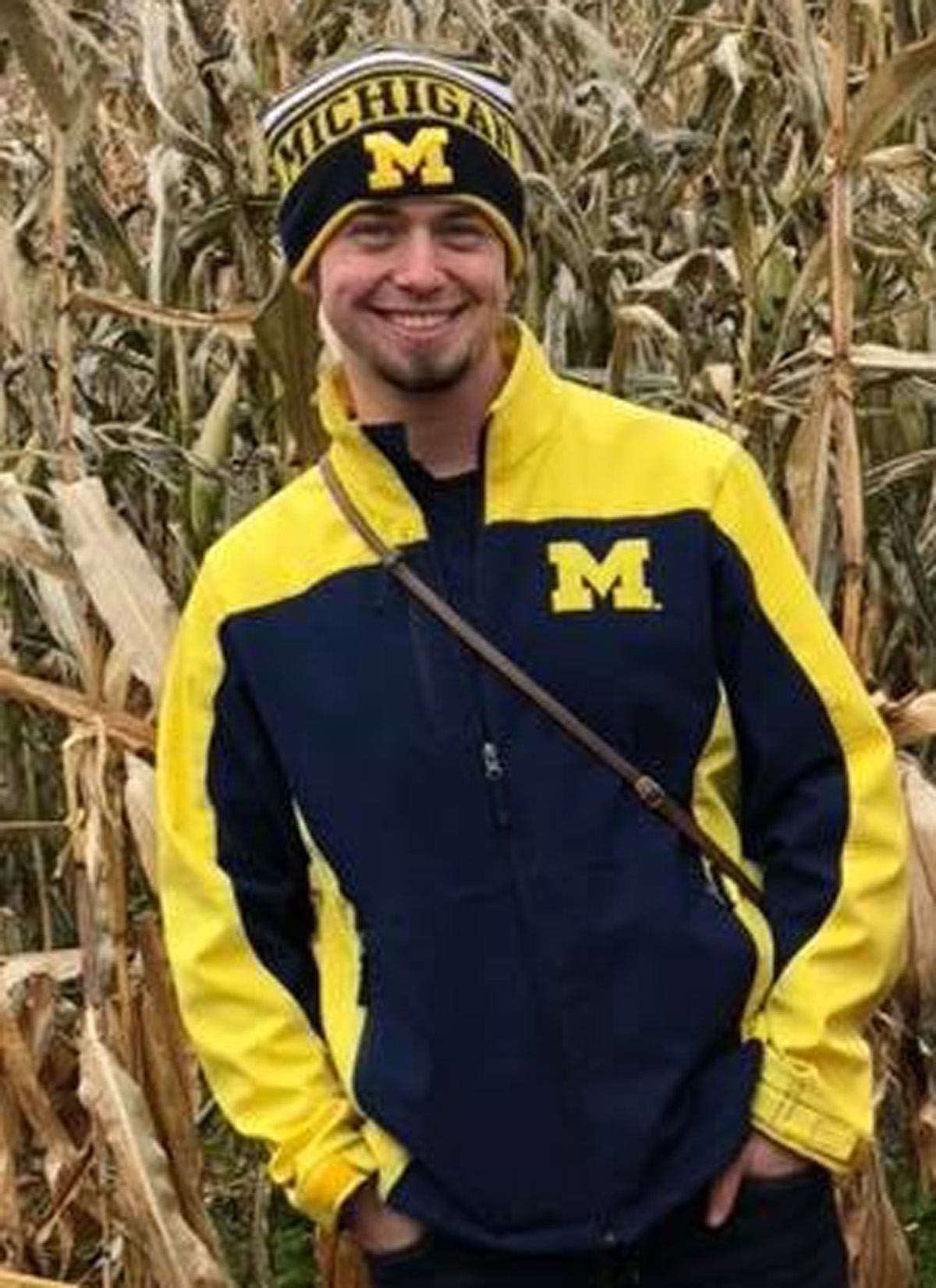 A portrait of student government president Mitchel Dobson-Green, clad in head-to-toe maize and blue gear.