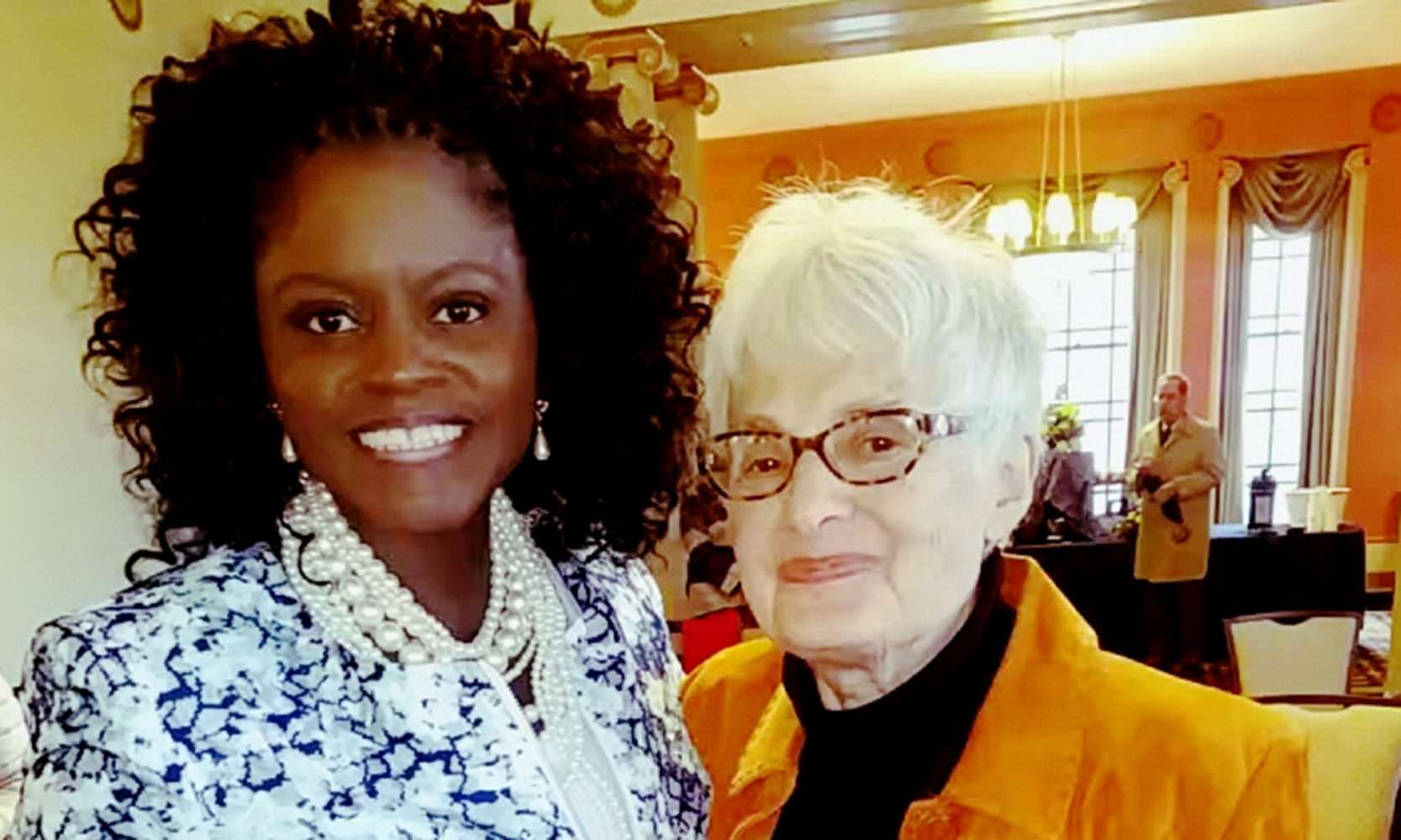 Sharon Harris standing with older white woman.