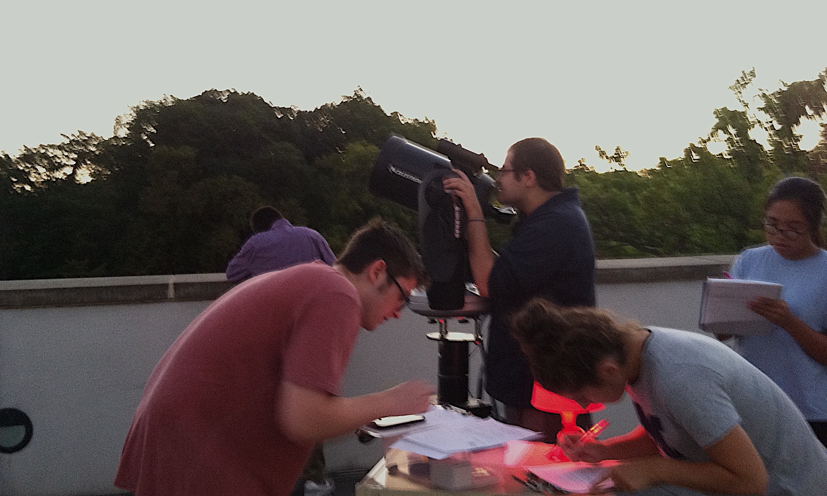 Students learning to use telescopes