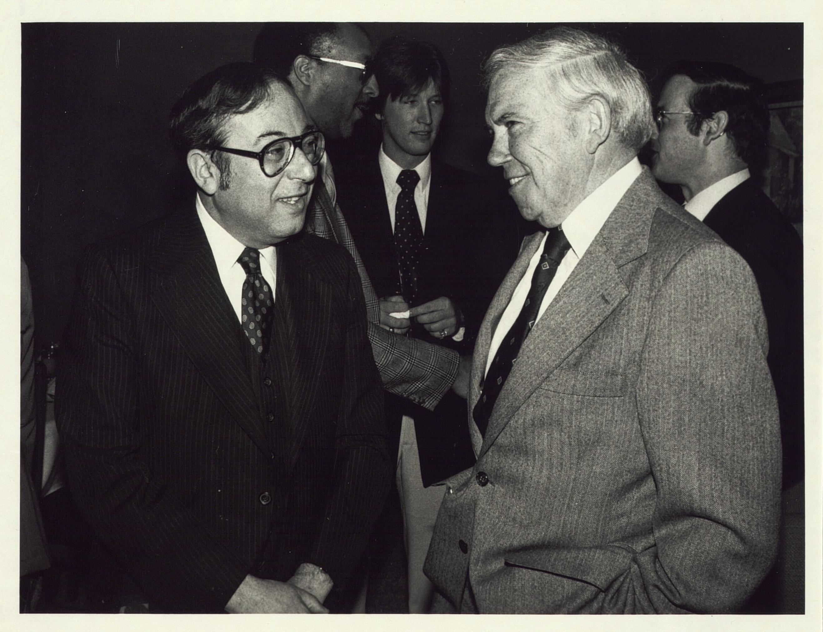 Acting Chancellor Bernie Klein talks to UAW President Doug Fraser following Spring 1980's Commencement ceremony.