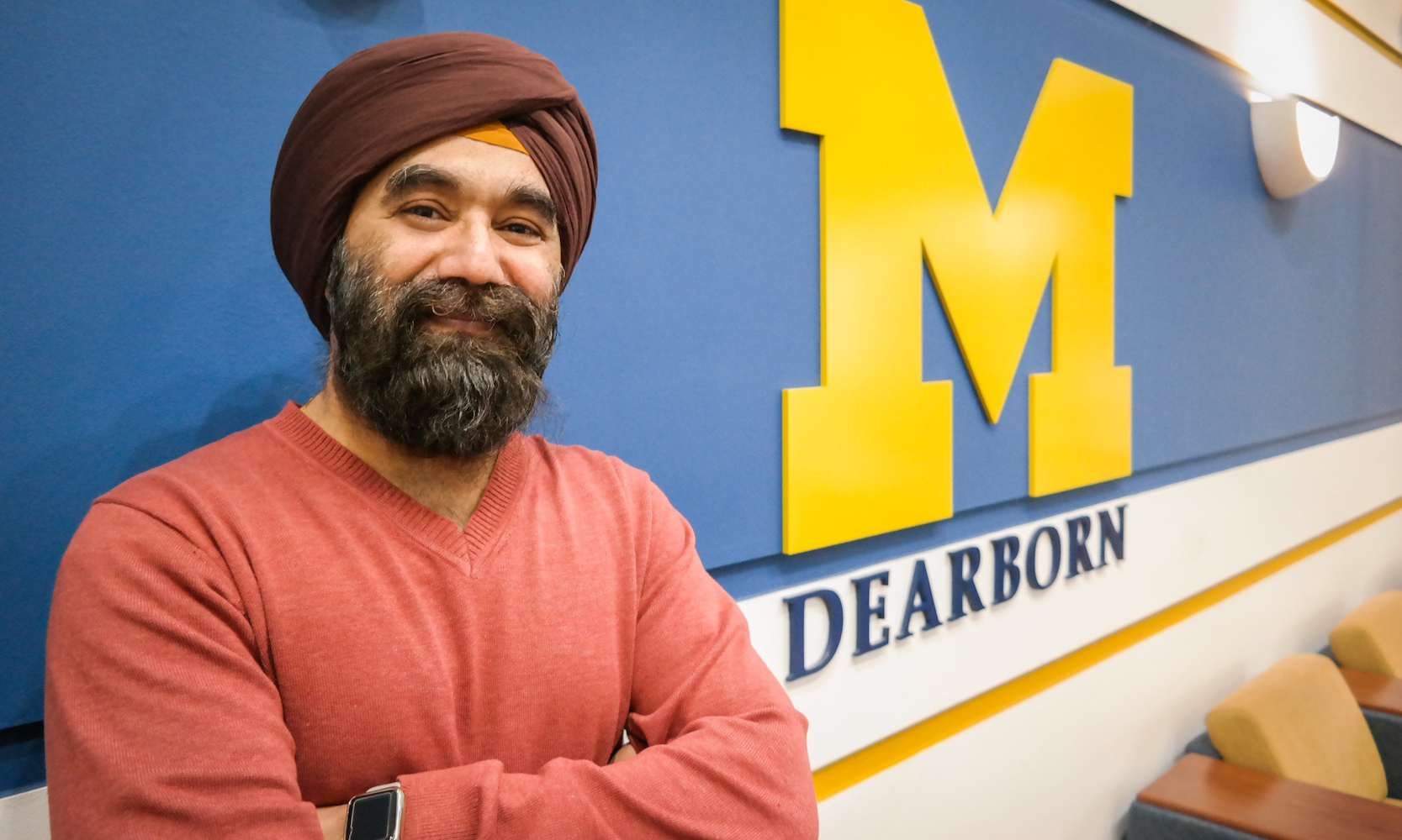 Vivek Singh standing in front of UM-Dearborn background.