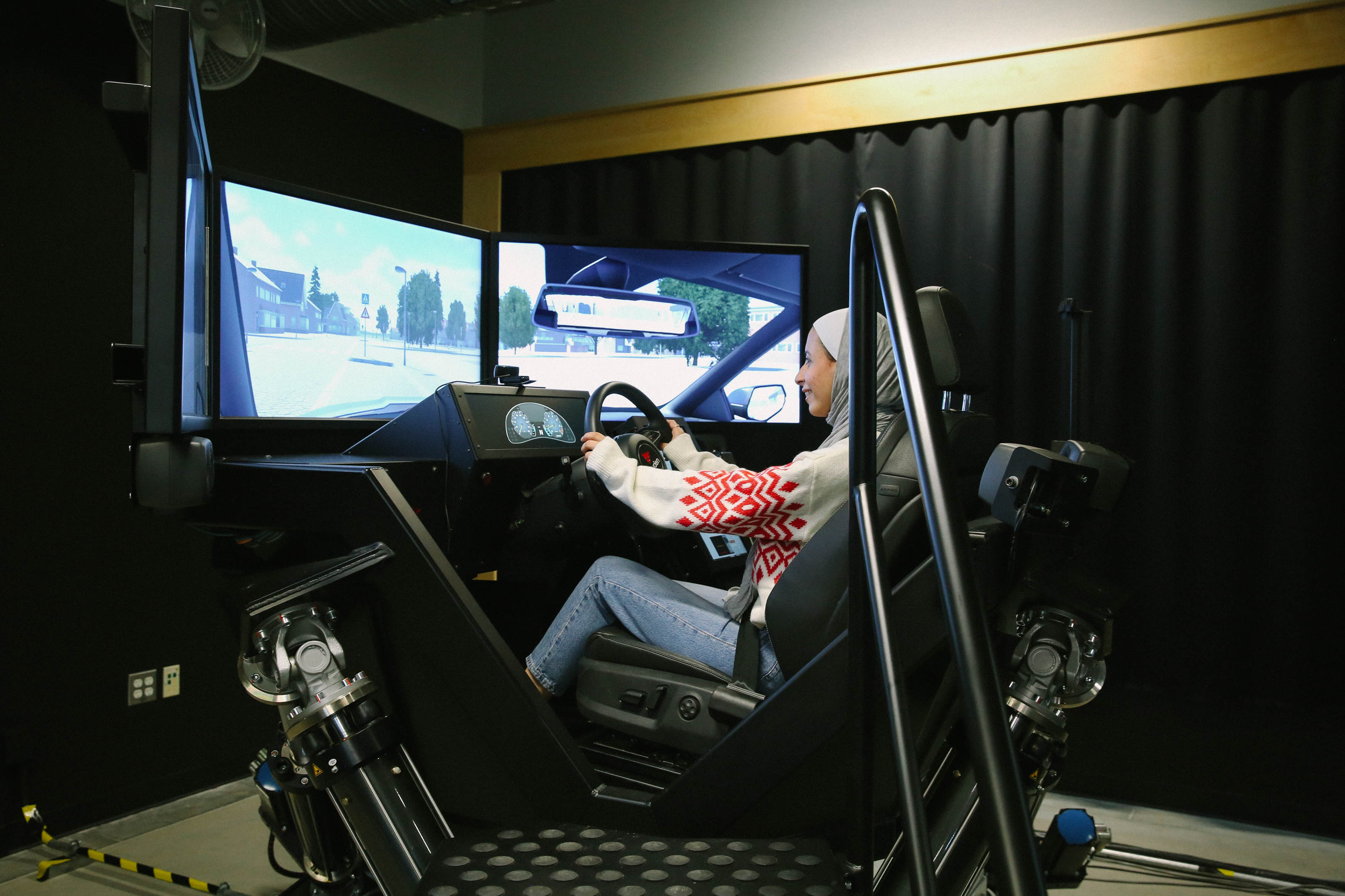 A student sits in a driving simulator