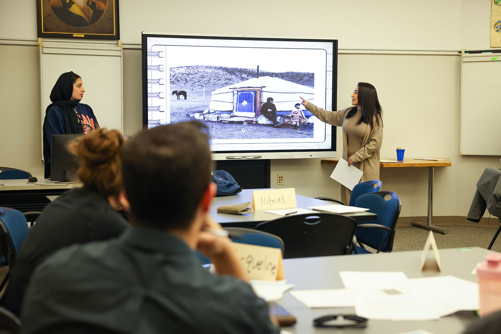 Students presenting their work in front of a class.