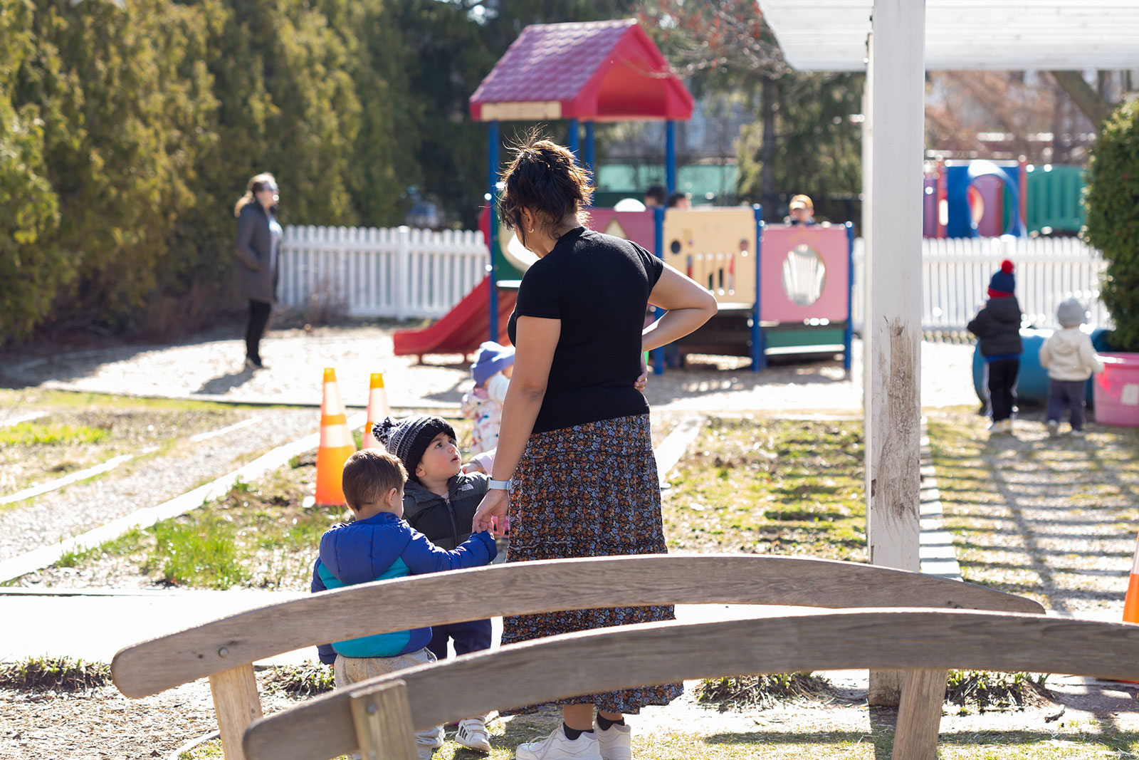 Teacher with children playing outside