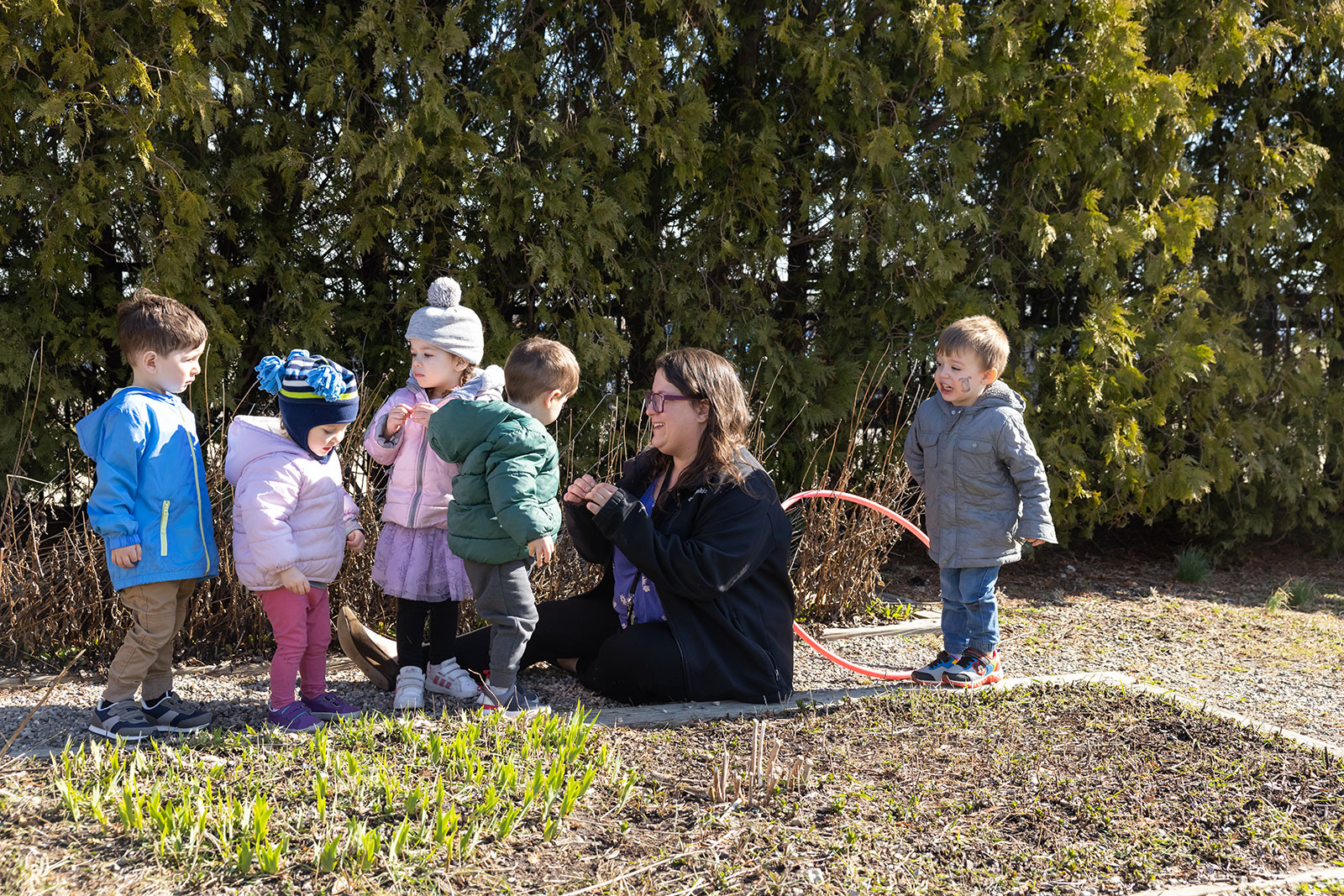 children and teacher playing outside