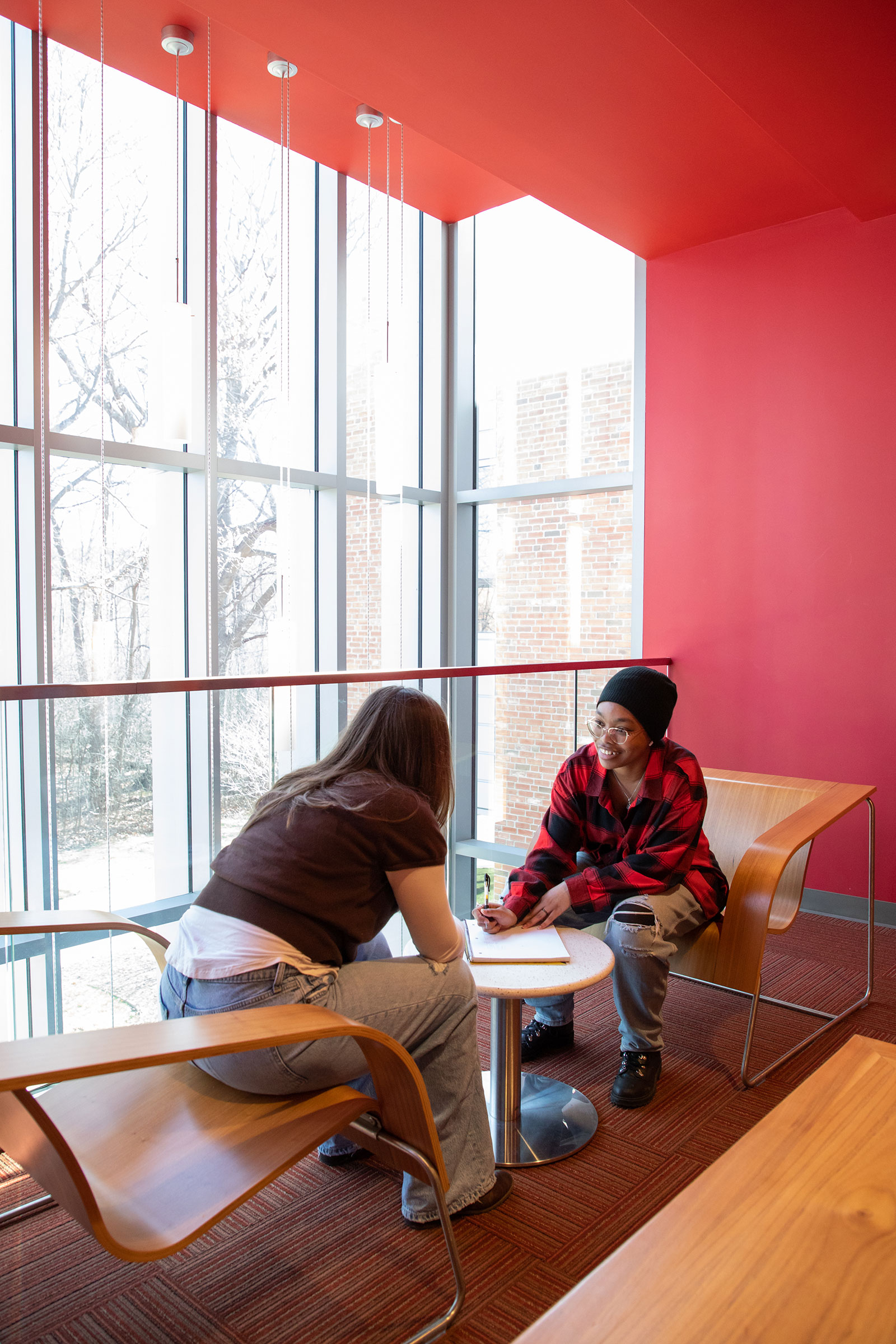 students discuss coursework in commons area