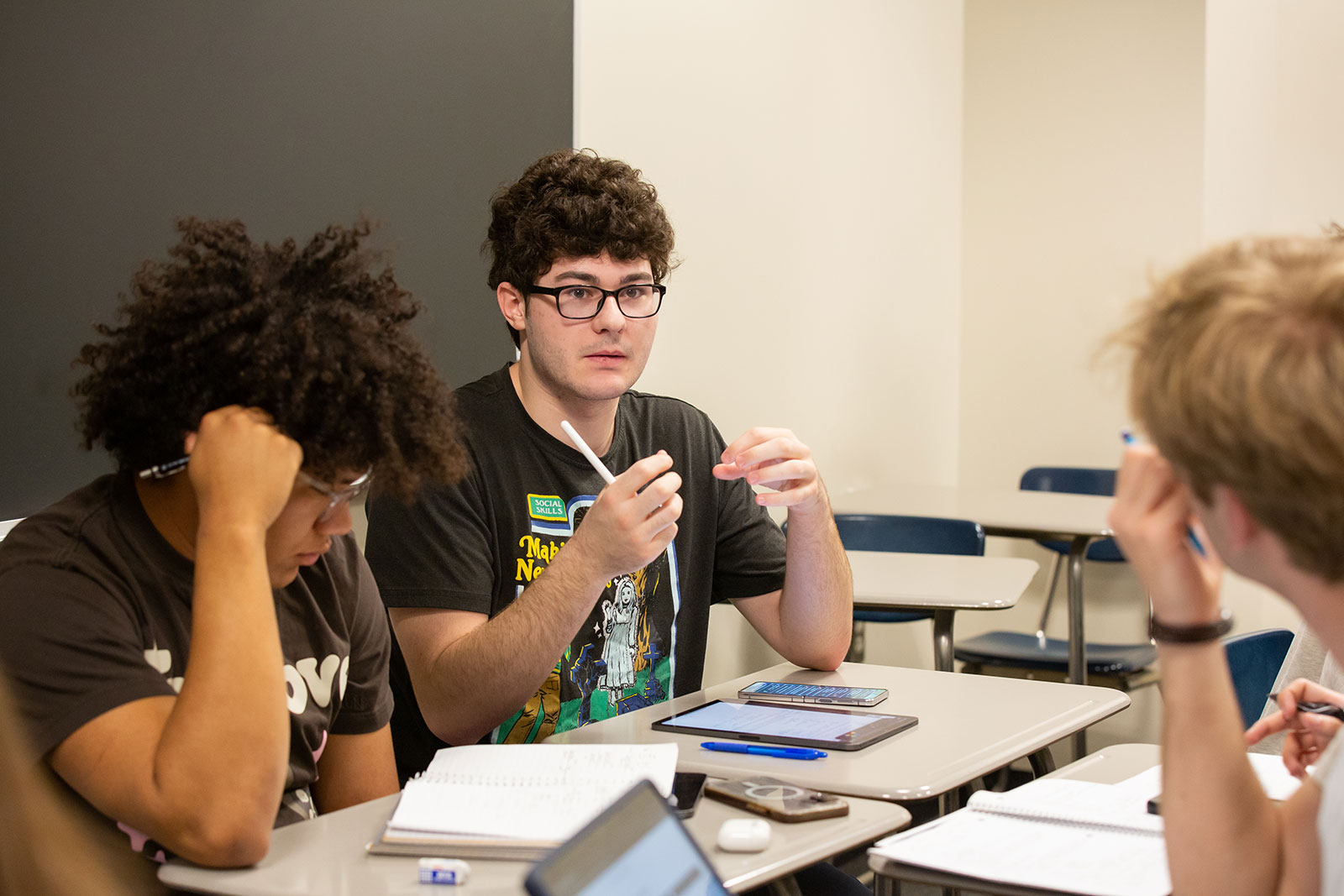 Students discuss coursework in a class