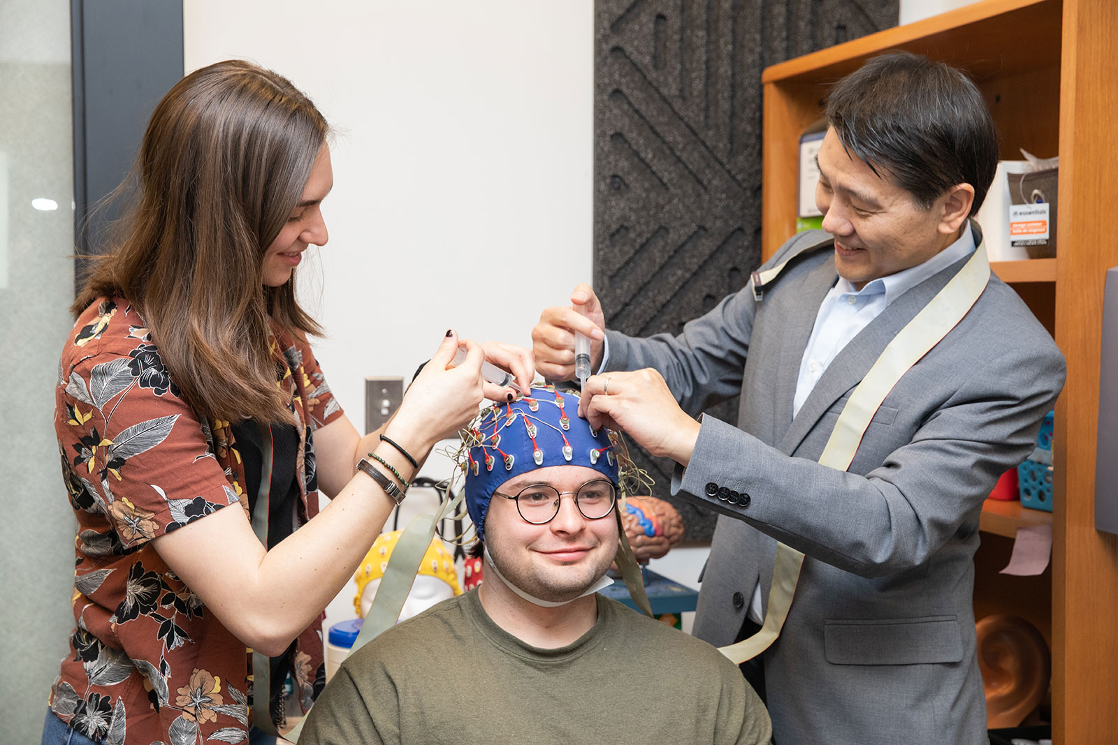 Students and professor participate in a brain wave activity for psychology