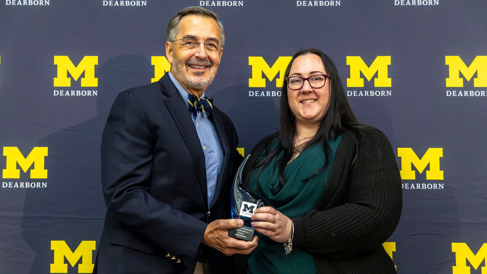 Molly Manley receives her award for Community Engagement with Chancellor Domenico Grasso